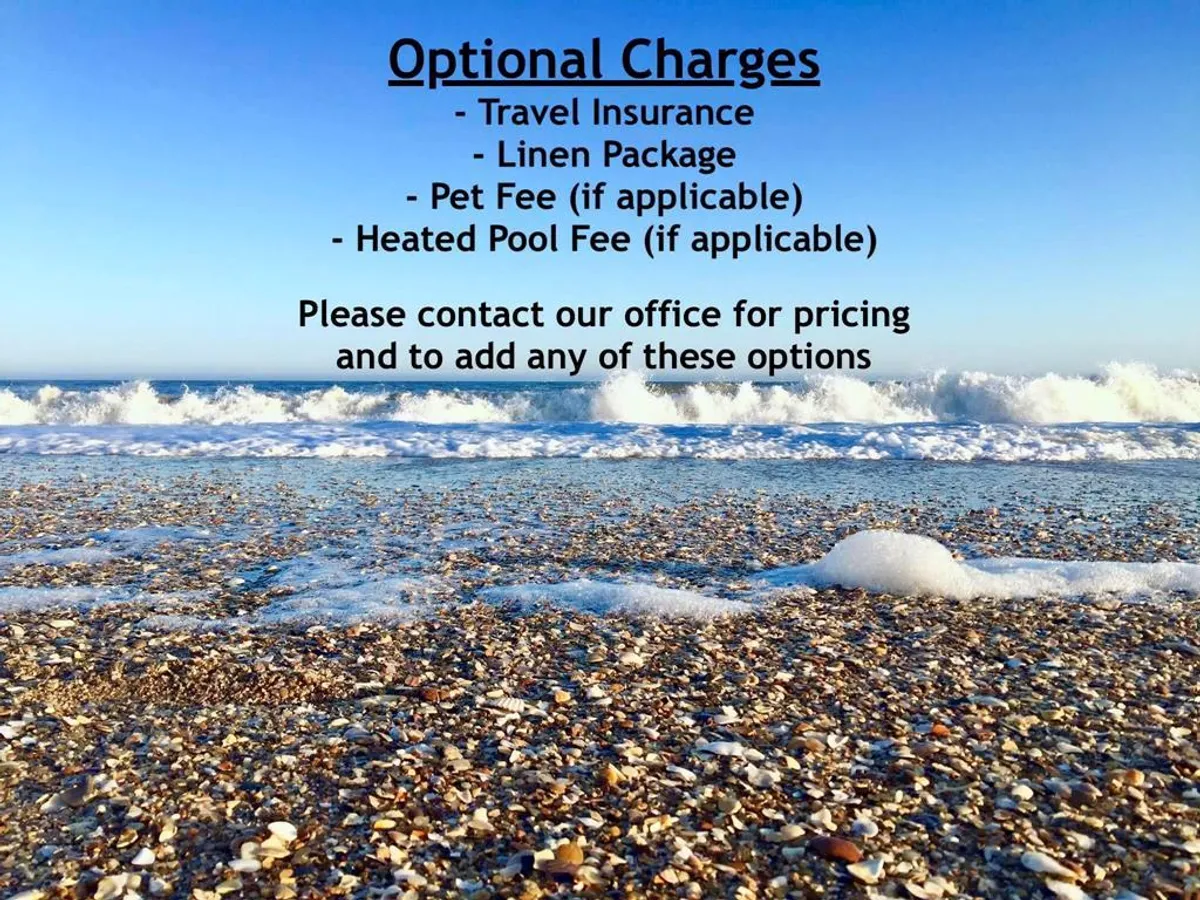 A tranquil stretch of sandy beach framed by gentle ocean waves and scattered seashells, with the warm glow of a sunset enhancing the scene. The beach is ready for sandcastle building, seashell collecting, and other family activities.